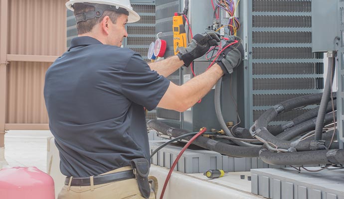 A person working on repairing an air conditioning unit.