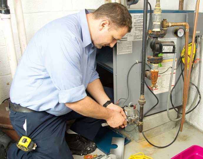 expert technician repairing a furnace