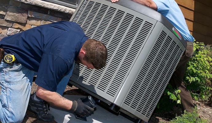 A person is installing outdoor unit of AC