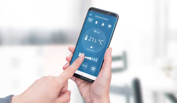 Person changing temperature using smartphone