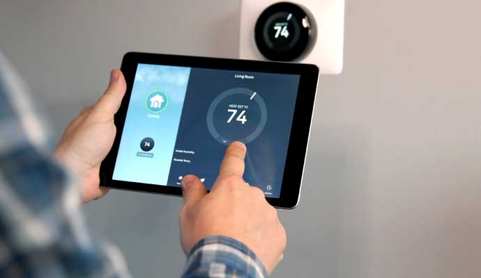 Person controlling thermostat using smart device