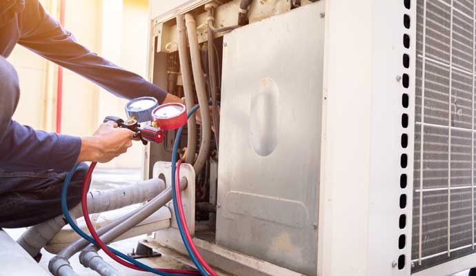 An expert inspecting heating system