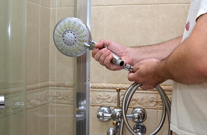 Professionals diagnosing and addressing showerhead problems for peak performance.