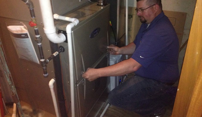 Professional worker repairing furnace