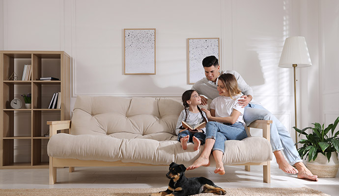 happy family sitting on a white sofa in a living room