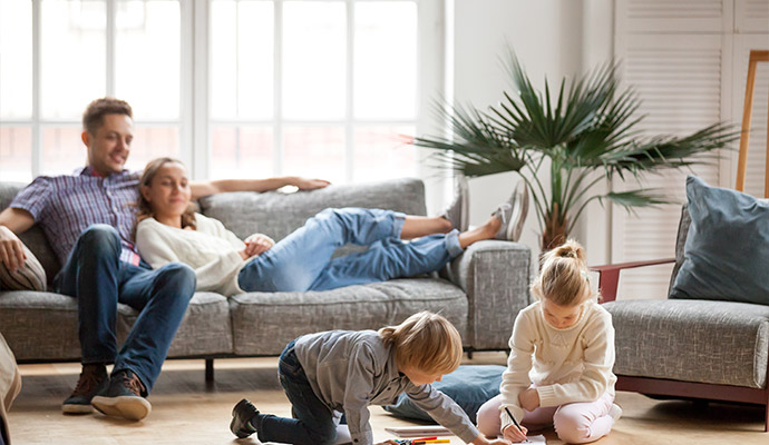 a happy family enjoying good-indoor air quality sitting in a living room