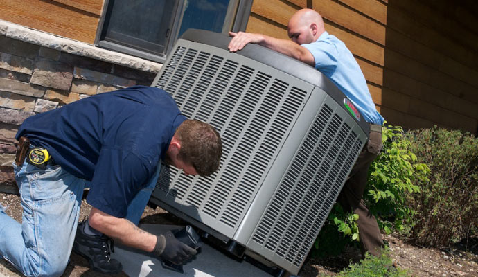 two workers replacing heating system