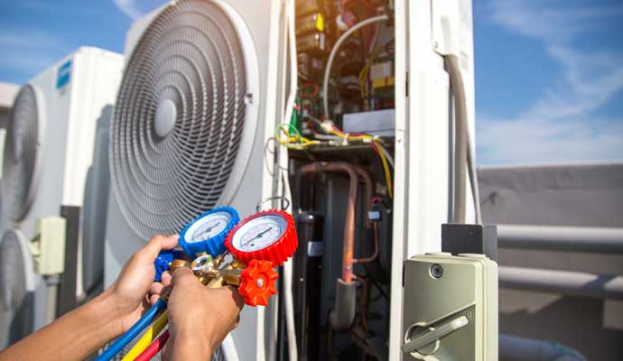 Professional inspecting heating system using HVAC Gauges