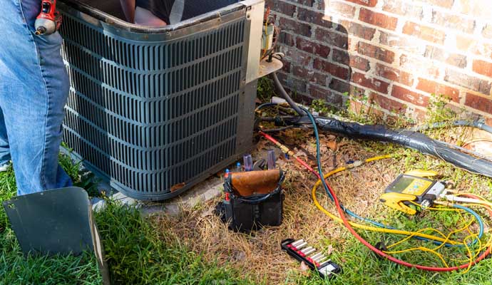 Professional repairing hvac system using equipment