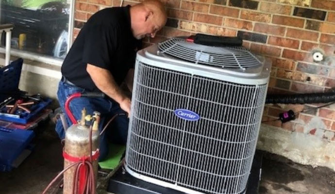 Professional worker maintaining HVAC unit