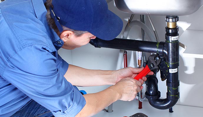 Technician repairing plumbing expertly