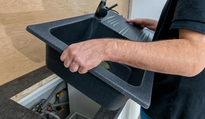 Professional worker installing sink