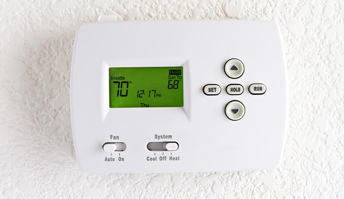 wall-mounted thermostat with digital display